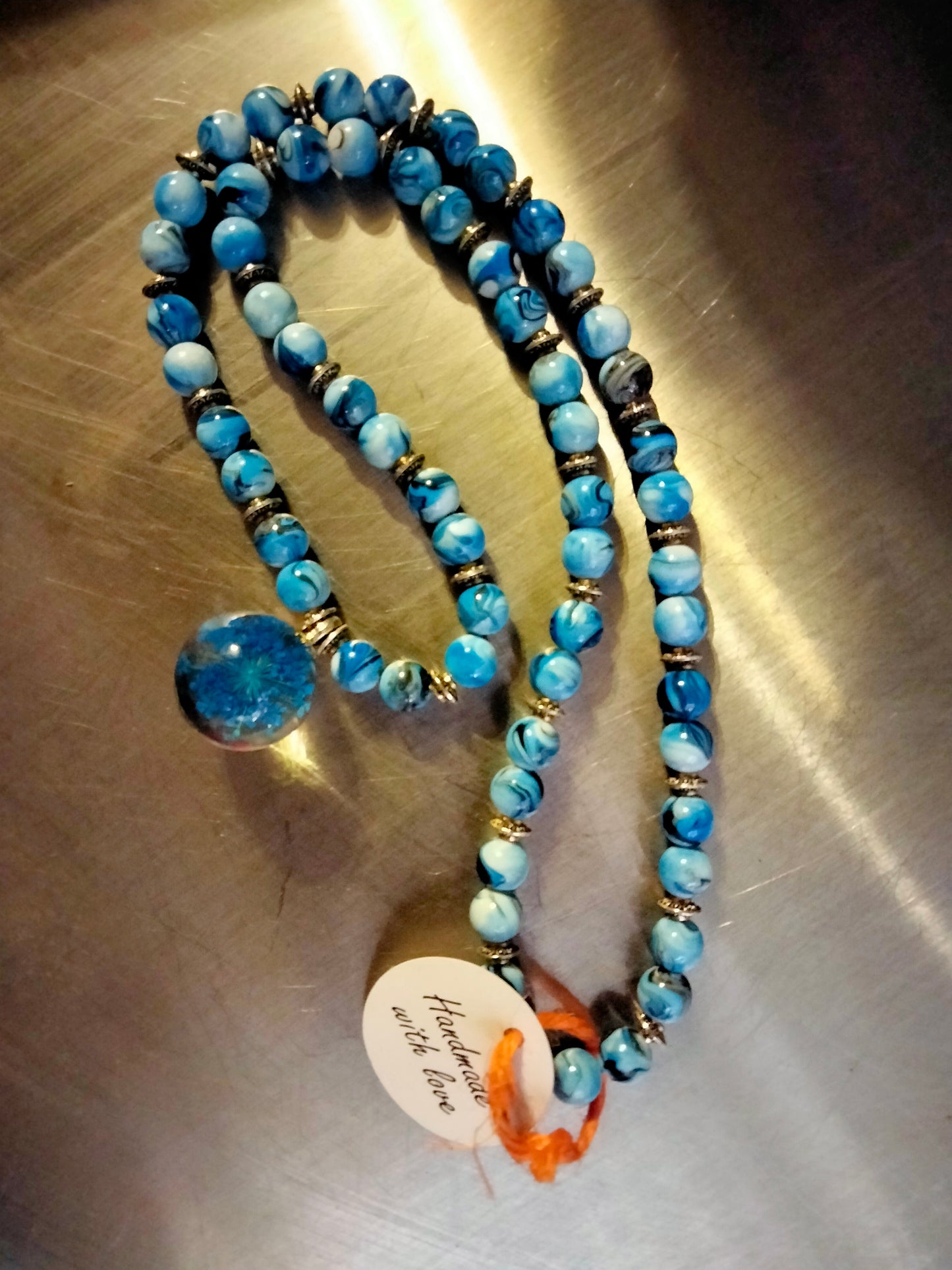Blue beaded necklace with wisp pendant by Peacemade