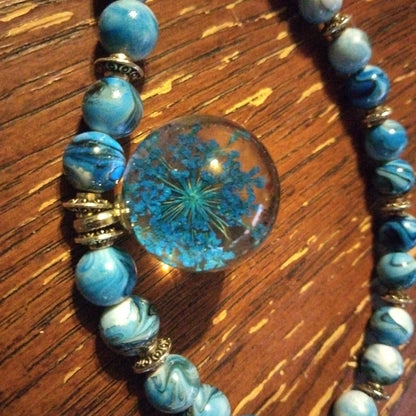 Blue beaded necklace with wisp