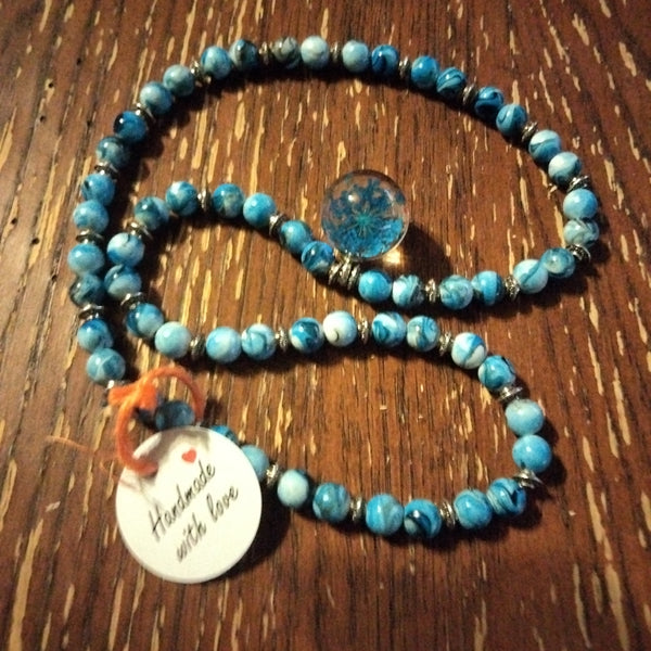 Blue beaded necklace with wisp  pendant by Peacemade